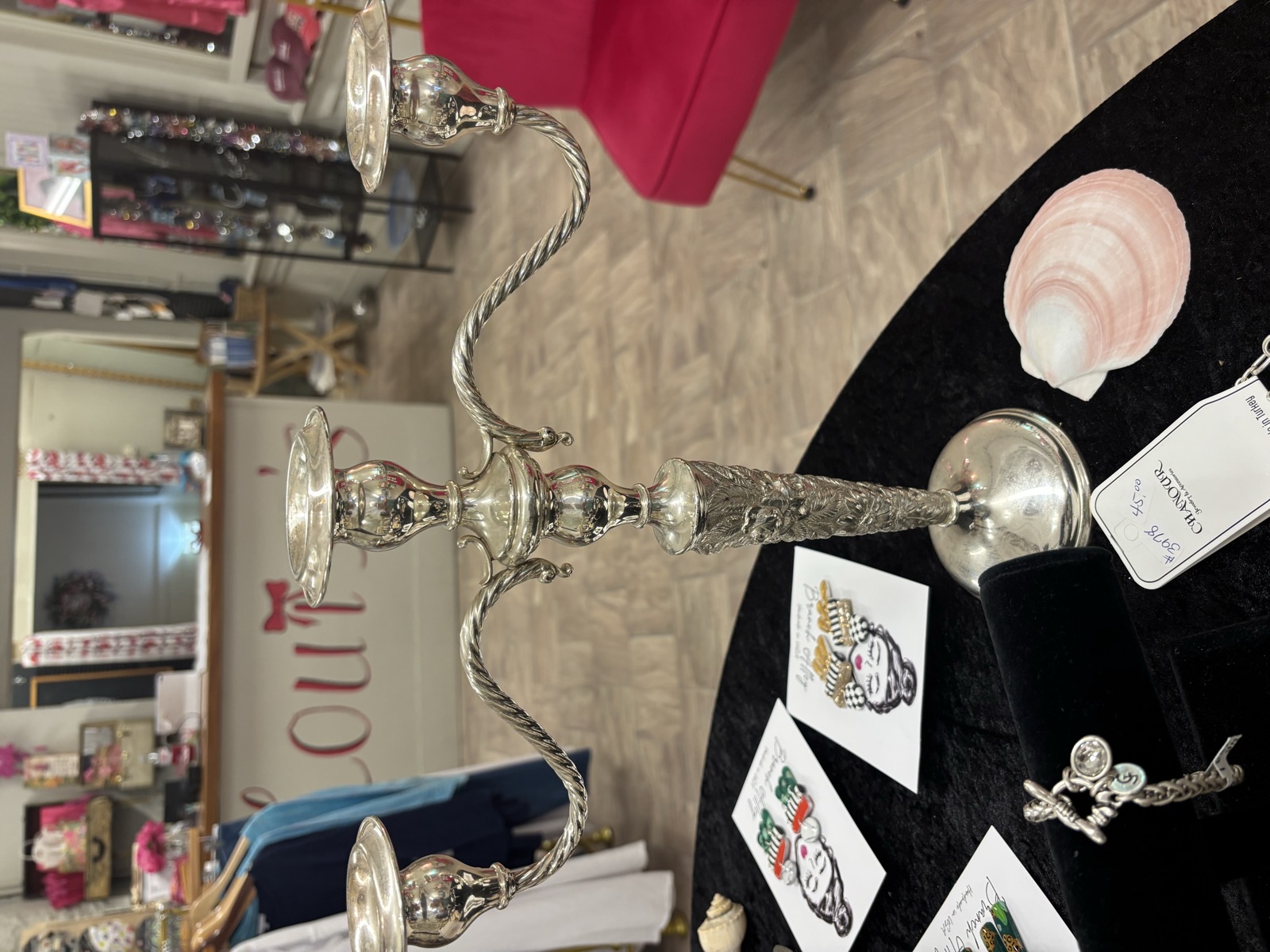 Louise Lankford's three-arm candelabra displayed on the shop's jewelry table