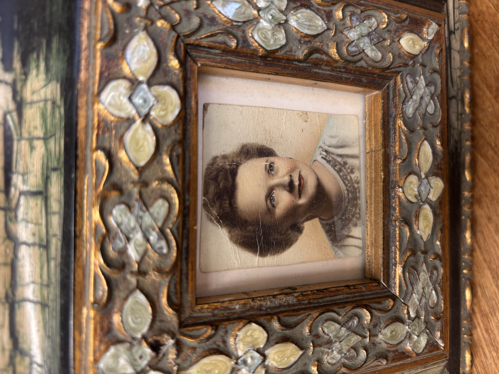 A hand-tinted portrait of a young Louise Lankford in its ornate gold frame