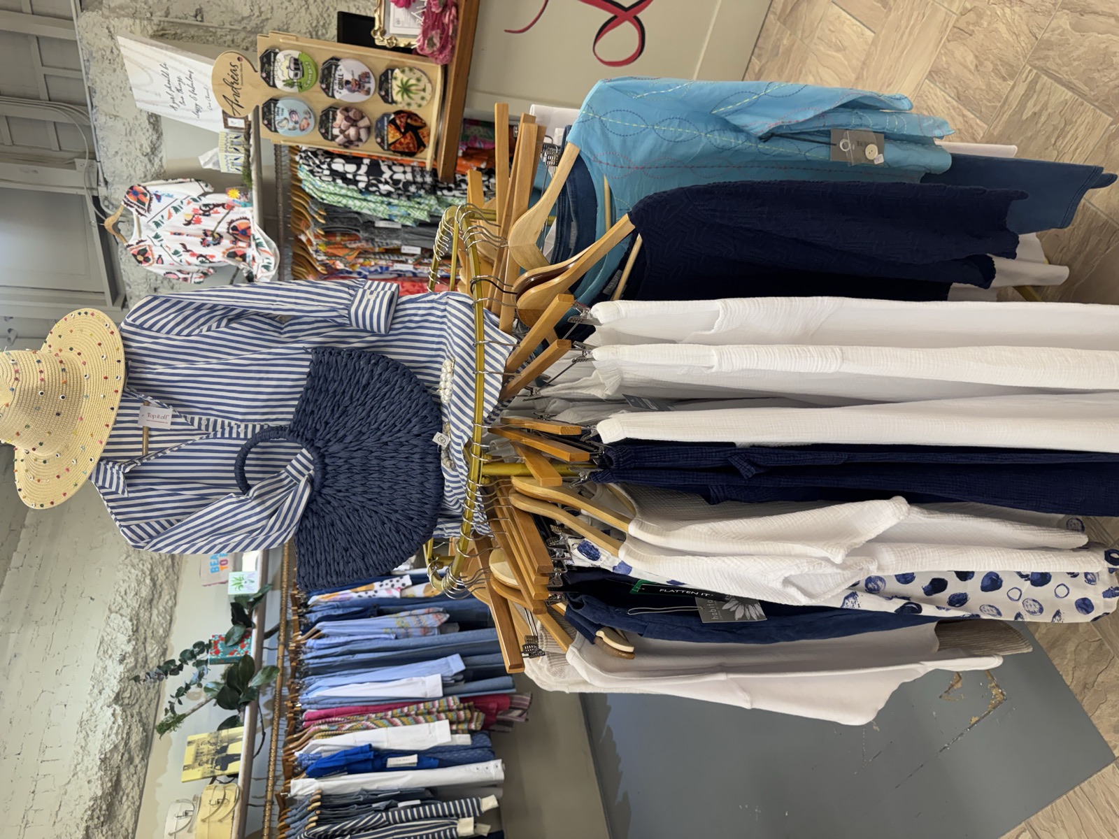 A straw hat and woven navy bag styled above the round rack